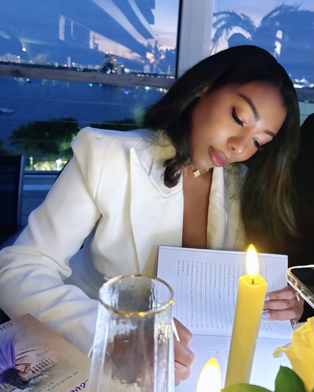 Chilen writing by candlelight at her book launch